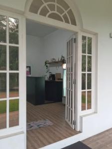 an open door into a room with a kitchen at The Inn At Matale in Matale