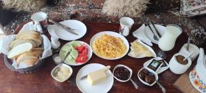 a table topped with white plates and bowls of food at Ideal in Akhaltsikhe
