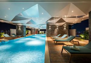 a pool at a hotel with lounge chairs at Amanaki Thao Dien in Ho Chi Minh City +153 photos