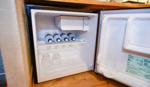 an open refrigerator with water bottles in it at Kamegawa Onsen HATAGO Yuyu in Beppu