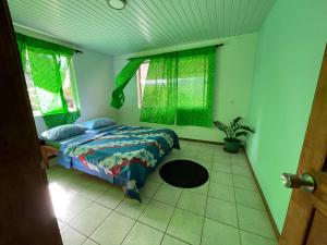 a bedroom with a bed and a potted plant at Akivai Lodge Ua-Pou in Hakamui