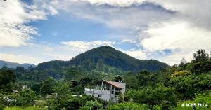 a mountain in the distance with a building in the foreground at 4 Aces Ella in Ella