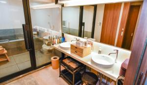 a bathroom with two sinks and a large mirror at Resort Yufuin - Grandpia Resort Yufuin in Yufuin +52 photos