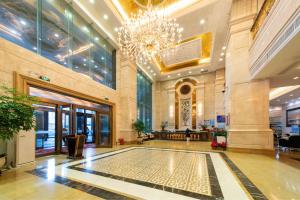 a lobby of a building with a chandelier at PingTan YuCheng Seaview Blue Smart Hotel in Pingtan