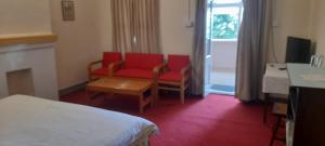 a hotel room with a bed and a chair and a table at BRIGHTLANDS HOTEL in Murree