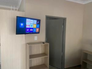 a flat screen tv on the wall of a room at Aloe Guest Rooms in Bloemfontein