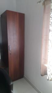 a room with a wooden door and a window at PPH Living B S K in Bangalore