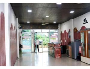 a person walking into a store with the door open at Hotel Sanginee, Maheshwar in Maheshwar