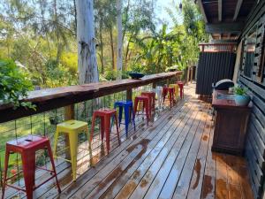 a row of colorful stools on a deck at Birdsong Retreat BnB on Lamb Island 