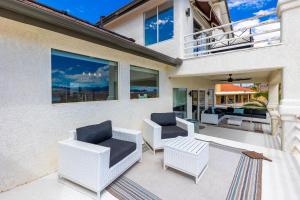 a patio with chairs and a couch on a house at LakeView Home Minute From New Launch With Pool And Spa in Lake Havasu City
