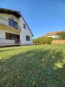 a building with a large grass field in front of it at House For Rent in Pristina