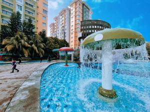 a fountain in the middle of a city with buildings at Wet Spot Amusement Water Themepark Family Suite - Enjoy Biggest Water Themepark Fun in Melaka Town in Malacca
