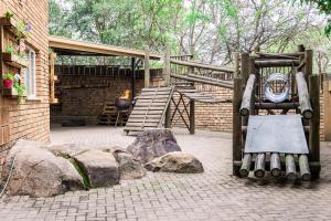 a patio with some rocks and a wooden structure at Stamvrug 9 B in Nelspruit