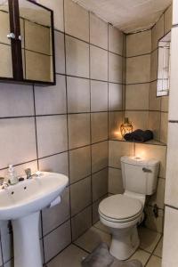 a bathroom with a toilet and a sink at Stamvrug 9 B in Nelspruit
