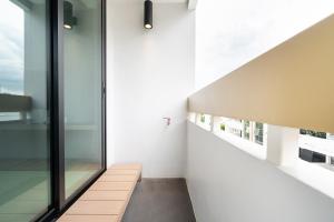 a hallway of a house with white walls and windows at LiveZen Bangkok Sukhumvit in Khlong Toei