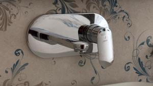 a hair dryer on the wall of a bathroom at Rock Castle Residency in Leh