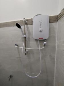 a white appliance is hanging on a wall at Suria Paradise Lodge in Ranau +27 photos