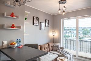 - un salon avec une table et un canapé dans l'établissement Apartament Nad Stawem, à Gdańsk