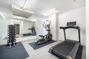 a gym with two exercise bikes and a mirror at LiveZen Bangkok Sukhumvit in Khlong Toei