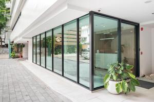 a large group of glass doors on a building at LiveZen Bangkok Sukhumvit in Khlong Toei