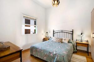 1 dormitorio con cama, escritorio y ventana en Casa del Mar en Tacoronte, en Tacoronte
