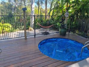 a hot tub sitting on top of a wooden deck at Birdsong Retreat BnB on Lamb Island 