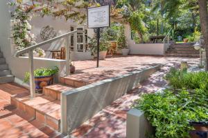 a patio with stairs and a fence with plants at Montagu Country Hotel in Montagu