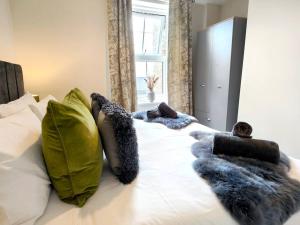 a bedroom with a white bed with pillows and a window at Carvetii - ANNE House Room 2 - Dbl bed First floor en-suite in Carlisle