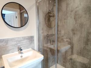 uma casa de banho com um lavatório e um chuveiro com um espelho. em Carvetii - ANNE House Room 2 - Dbl bed First floor en-suite em Carlisle