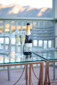 a bottle of wine and two wine glasses on a table at Montagu Country Hotel in Montagu