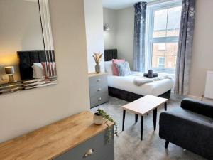 a small living room with a bed and a couch at Carvetii - ANNE House Room 3 - Triple bed first flr en-suite in Carlisle