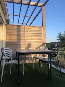 a table and chairs sitting on a patio at T2 avec piscine et terrasse dans résidence arborée in La Rochelle