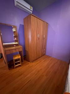 a room with a wooden cabinet and a wooden floor at Heaven Guesthouse in Pakse