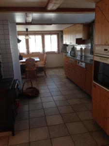 a kitchen with a table and a dining room at Ferienhaus Rütiweid in Appenzell