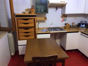 a kitchen with a table and a stove in it at Monolocale Palombara Sabina in Cretone +1 photo
