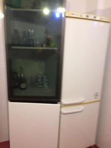 a white refrigerator with a glass door in a kitchen at Monolocale Palombara Sabina in Cretone