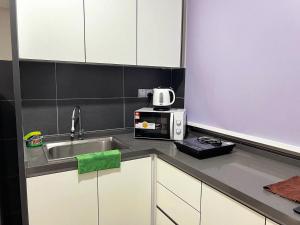 a kitchen with a sink and a microwave at SKS Habitat Larkin Economy Business Unit in Johor Bahru