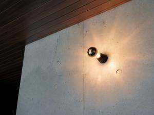 a wooden door with a brass door knocker on it at Tanegashima Araki Bekkan in Nishinoomote