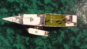 an aerial view of a ship in the water at familykomodocruise in Labuan Bajo