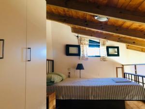 a bedroom with a bed and a window at apartment over the sea Private place to swim in Ravdhoúkha