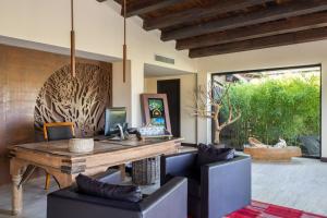 a dining room with a wooden table and chairs at Vallegrande Nature Resort by Geocharme in Cefalù