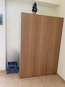 a large wooden cabinet with a potted plant on top of it at Villa Dimitris near the beach! in Karavómilos