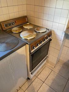 a stove in a kitchen with two pies on top at Villa Dimitris near the beach! in Karavómilos
