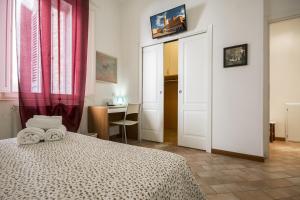 a bedroom with a bed with two towels on it at GH Paradiso - Apartments in Siena