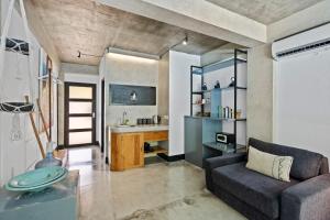 a living room with a couch and a table at Balissimo Suites Seminyak by Betterplace in Seminyak