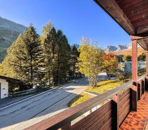 a view of a street from a porch of a house at Chalet Höfi - Studio in Arosa