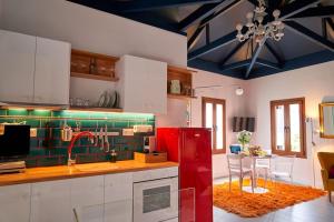 a kitchen with a red refrigerator and a dining room at #SimpliCity Modern Design Studio in Mytilene