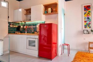 a kitchen with a red refrigerator in a room at #SimpliCity Modern Design Studio in Mytilini