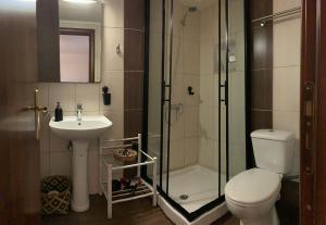 a bathroom with a shower and a toilet and a sink at Sweet Home Preveza in Preveza +10 photos