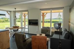 a living room with a couch and a table at Vakantieverblijf Weidezicht in Dorst